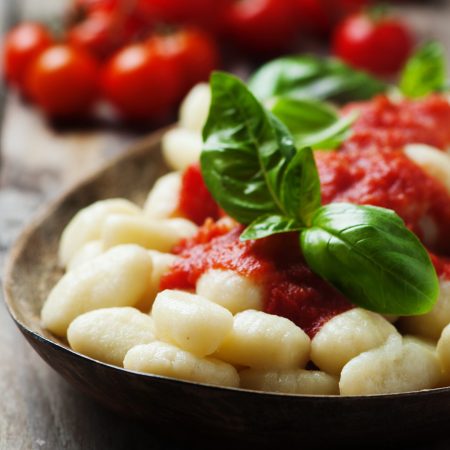 Italian gnocchi with tomato and basil, selective focus